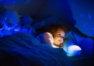 Little girl reading a book in Bedding Australia bed