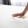 Hand making a hand print to Testing Orthopedic Memory Foam Core Mattress